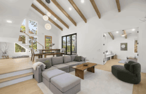 Travelers Rest Nest Cabin: Bright, modern living room with exposed beams and sectional sofa.